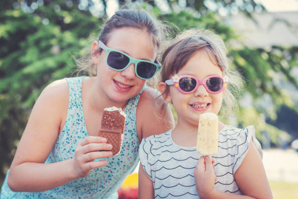 istock Sisters eating ice-cream in summer 870076824
