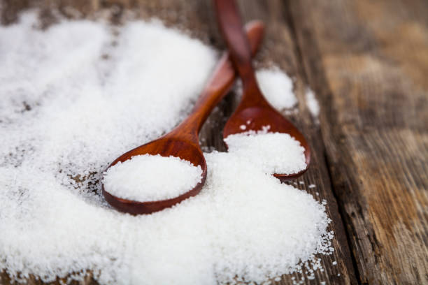 istock Two wooden spoons with sugar 870079376