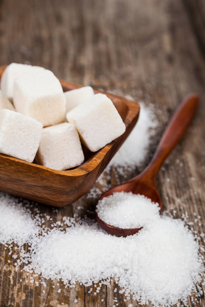 istock Sugar in a wooden bowl and a spoon 870079762