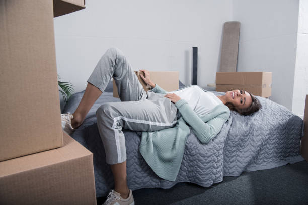 istock woman lying on bed at home 870090358