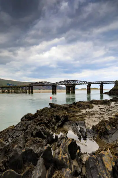 Barmouth Bridge, a wooden railway viaduct across the River Mawddach estuary; Barmouth, Wales