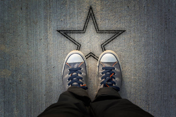 Sneakers on asphalt road with star shape