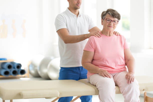 istock Personal masseur massaging senior woman 870095820