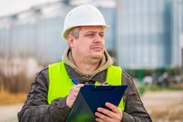 istock Worker with folder near the factory in winter 870105914