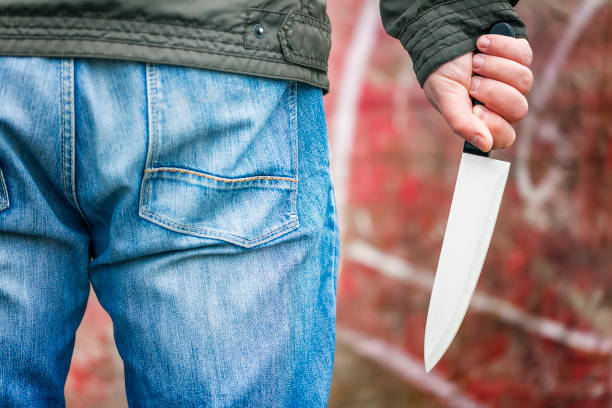 istock Man with a knife an opposite old wall 870106454