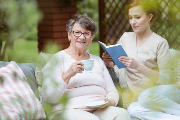 istock Nurse reading book in garden 870109274