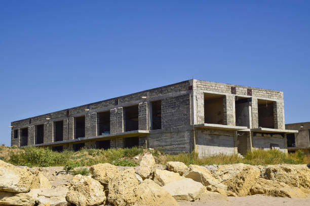 istock Unfinished building of gray block 870109426