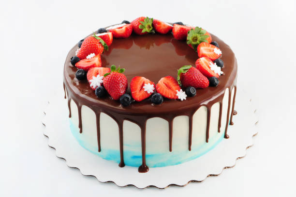 istock Birthday cake in chocolate with strawberries, blueberries and snowflake on white background. 870112896