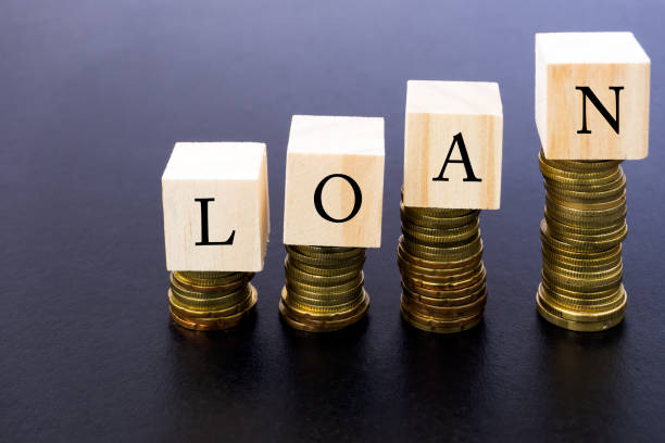 istock Loan Word on Wood Block on Top of Coins Stack 870114406