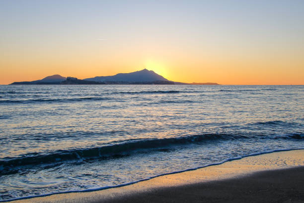 the beach of Miseno at sunset with Procida island on the background