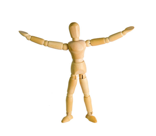 istock wooden doll stands on a background close-up 870126068