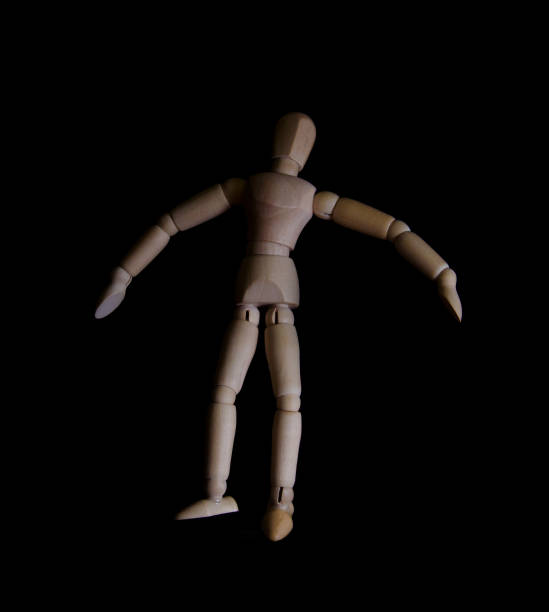 istock wooden doll figure falls down black gloomy background 870126258