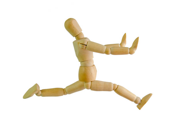 istock wooden figure mannequin running isolated on white 870126654