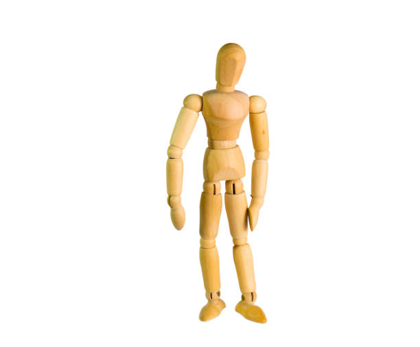 istock wooden doll stands on a background close-up 870129426