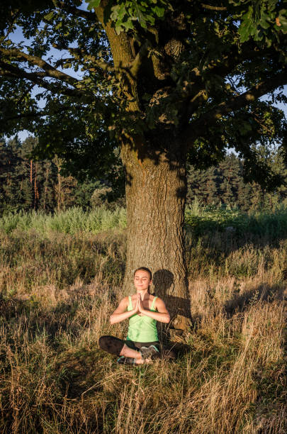 istock Beautiful woman making exercises on field road during 870131198