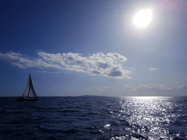 istock Seascape with a yacht on the horizon 870133714
