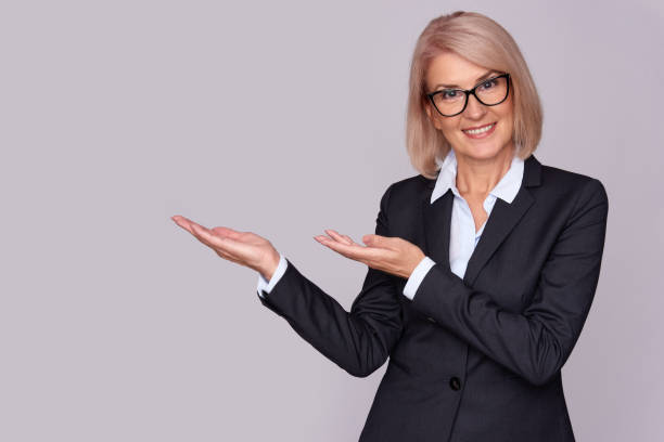 istock Smiling business woman pointing on copy space 870137546