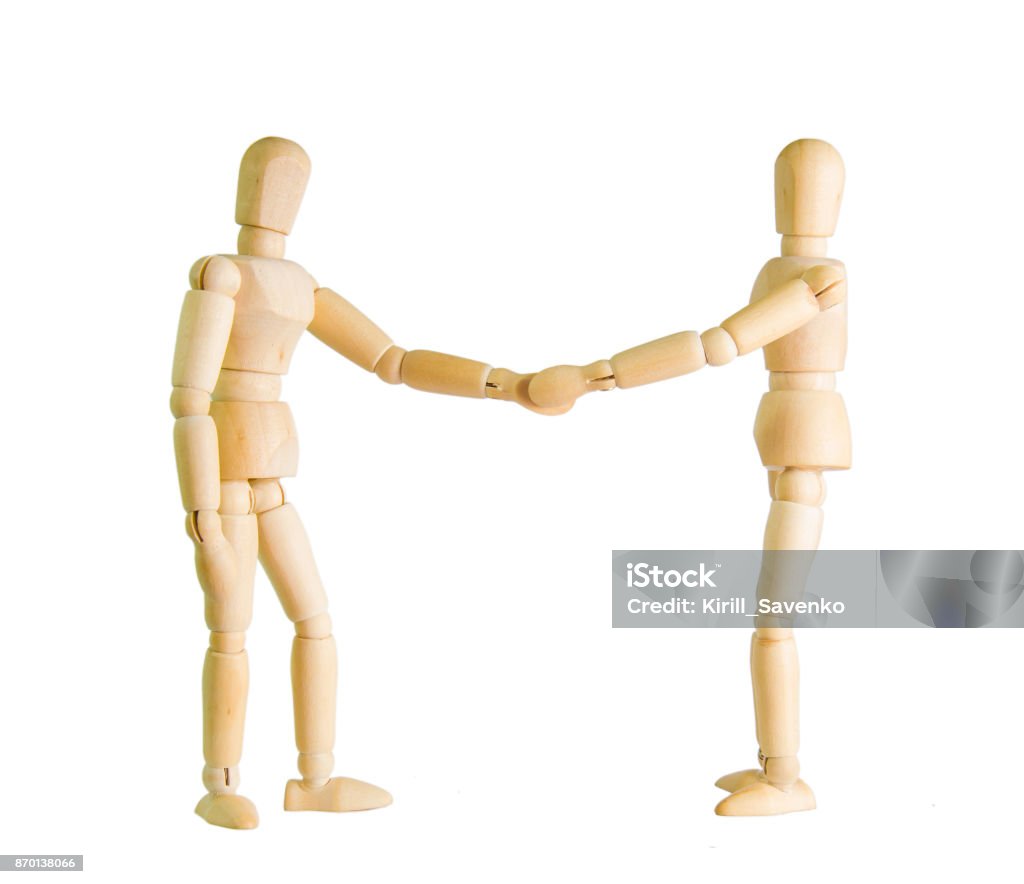 Two wooden figure dolls doing a handshake over a white background Mannequin Stock Photo