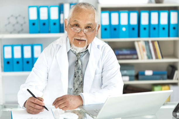 istock Medical specialist using laptop in cabinet 870142678