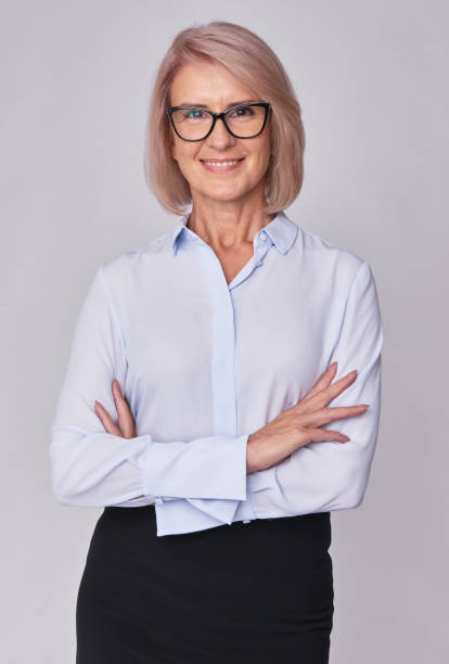 istock middle aged smiling business woman isolated 870143306