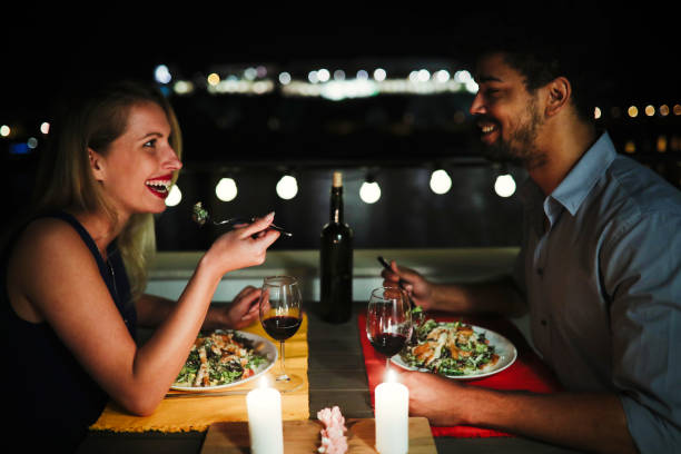 istock Beautiful couple in love having romantic dinner at night 870143776