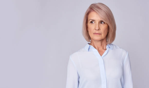 istock Serious senior woman looking away 870146410