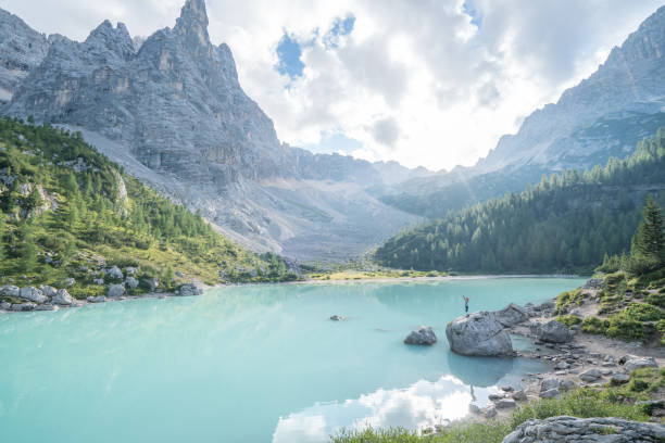 istock Hiker reaching Alpine lake, Dolomites, Italy 870146868
