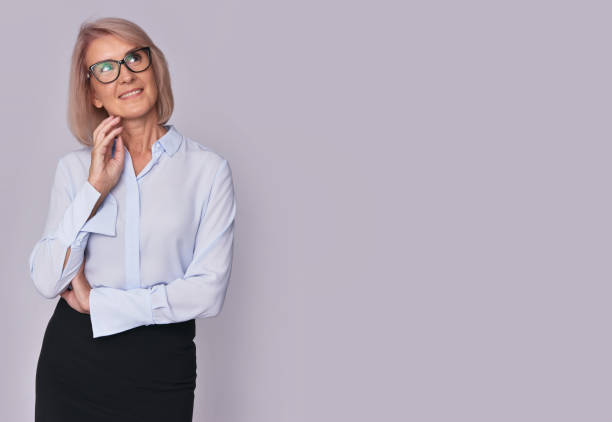 istock beautiful mature woman looking up 870146878