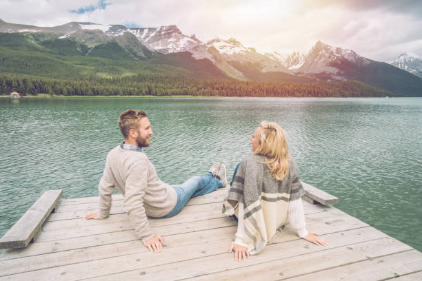 istock Young couple relaxing on lake pier in Canada 870147172