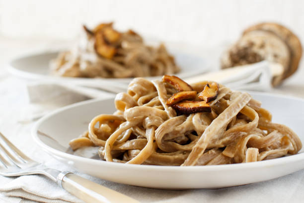 Whole wheat tagliolini with mushrooms Porcini Whole wheat tagliolini with mushrooms  Porcini Cepe stock pictures, royalty-free photos & images