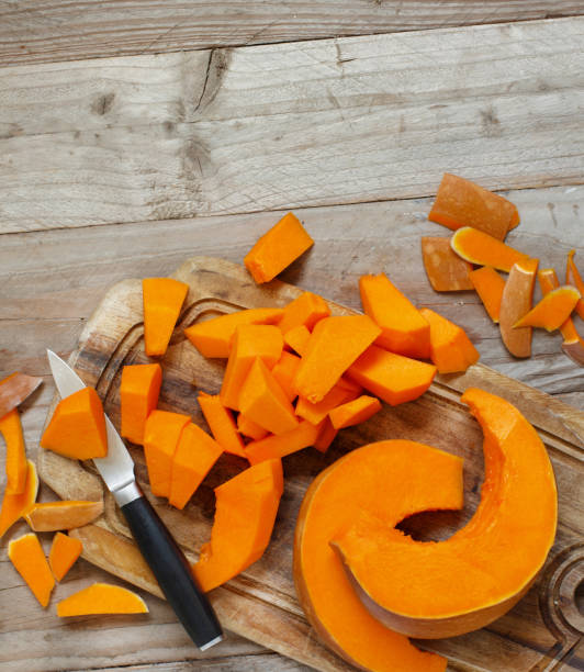 istock Pumpkin slices on a wooden background 870153190