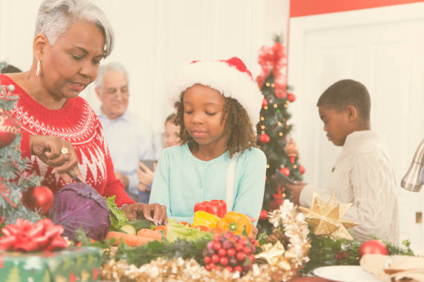istock Multi-ethnic family gather in home kitchen at Christmas. 870154304