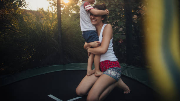 istock Boy and his mom on a trampoline 870158012