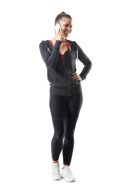 istock Young fit active female runner smiling and talking on the cellphone looking away. 870158030