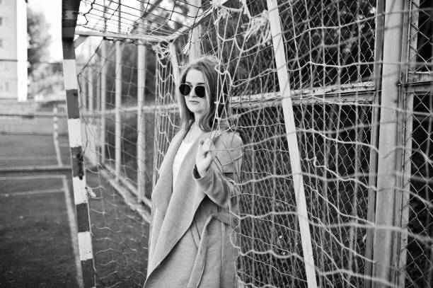 istock Girl in gray coat with sunglasses 870160462