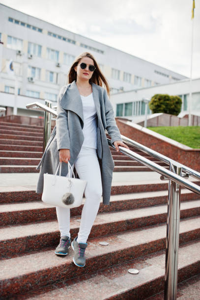 istock Girl in gray coat with sunglasses 870160538