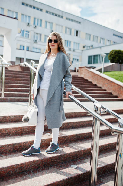 istock Girl in gray coat with sunglasses 870160580