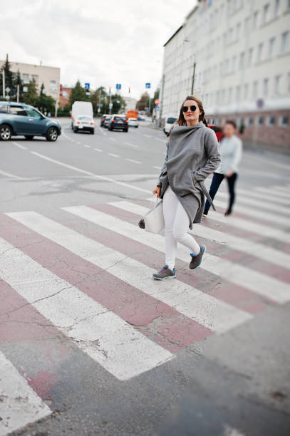 istock Girl in gray coat with sunglasses 870160892