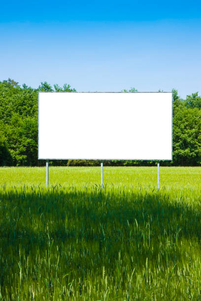 istock Blank advertising billboard in a green field - image with copy space 870161172