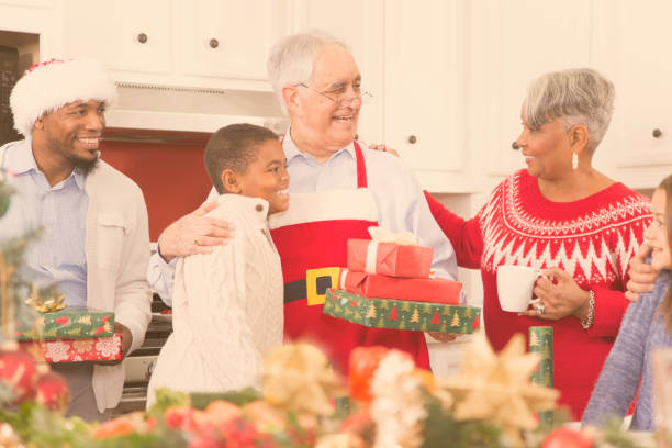 istock Multi-ethnic family in home kitchen at Christmas party. 870161550