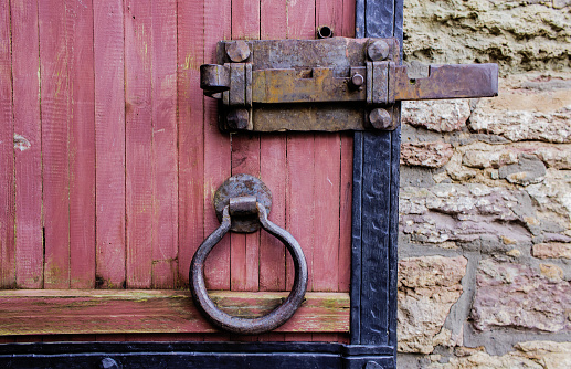 Close-up view of Mail box and door knocker on  wooden front door. Valença do Minho, Portugal.