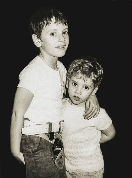 istock Vintage children hugging in front of camera 870165786