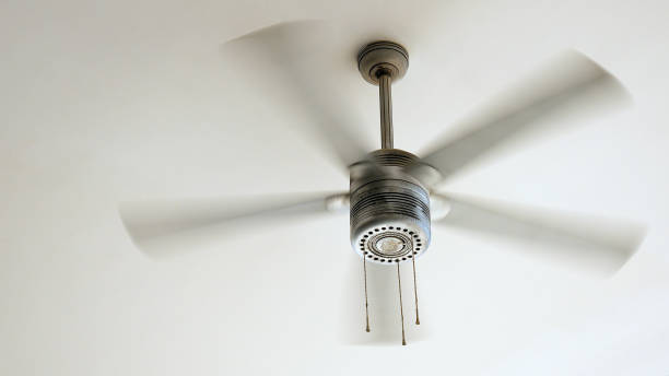 Ceiling fan rotating Ceiling fan is rotating at the ceiling of the room. Electric climate equipment. ceiling fan stock pictures, royalty-free photos & images