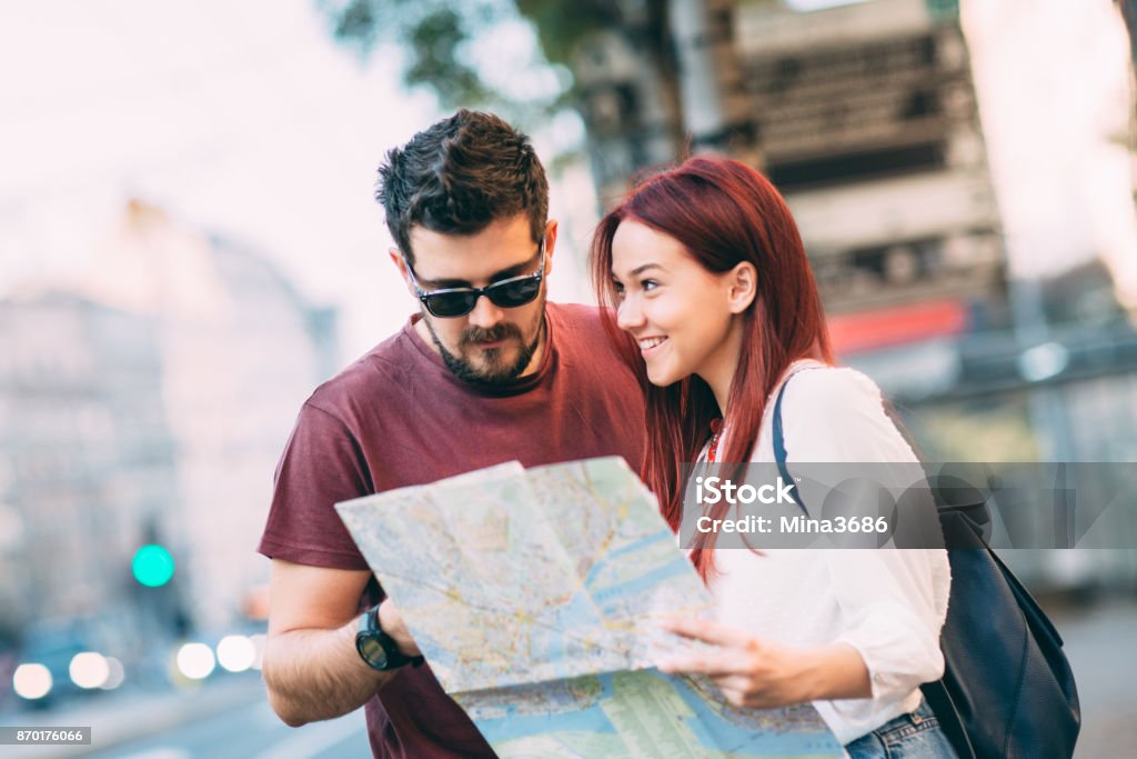 Travel Young couple traveler lost in the city using map Adult Stock Photo