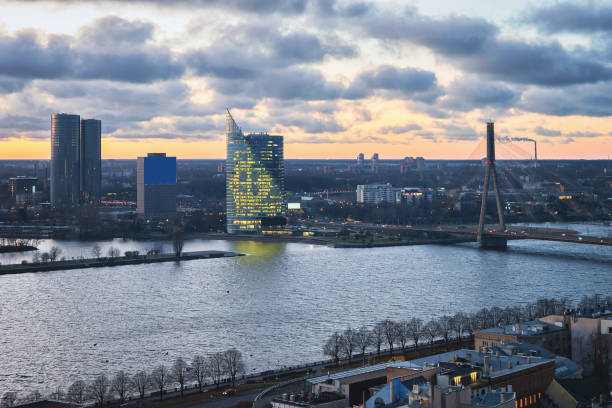 istock Riga downtown and Vansu Bridge over Daugava River at sunset 870176982