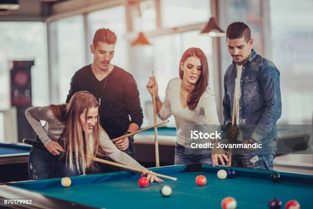Group of young friends playing billiard 945174 Stock Photo at Vecteezy