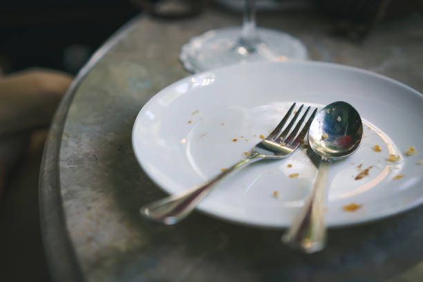 istock Eat completely empty dish on stone table. Fork and spoon in plate after finish eat food. concept of food delicious. 870183360