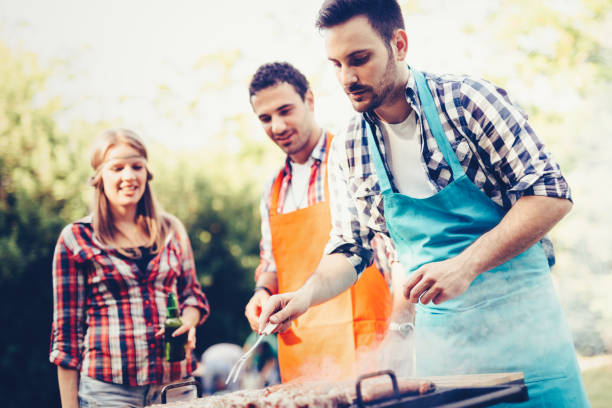 istock Happy people having camping and having bbq party 870192326