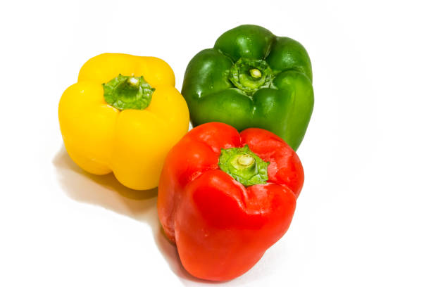 istock Yellow, green and red peppers isolated on white background 870192592