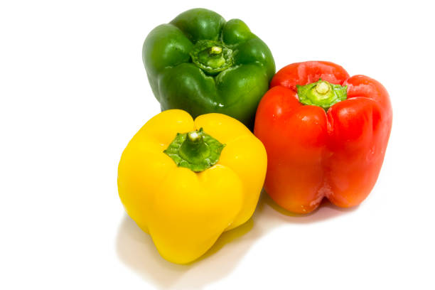 istock Yellow, green and red peppers isolated on white background 870192702